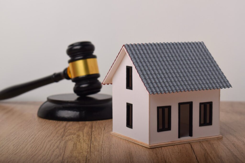 Small wooden house in front of a gavel