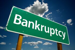 Bankruptcy Road Sign with dramatic clouds and sky.