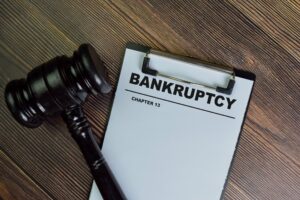 Sheet of paper on clipboard that says Chapter 13 bankruptcy next to a gavel