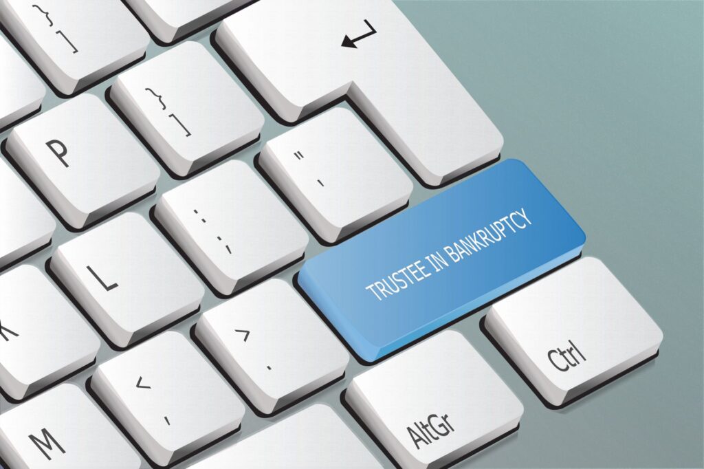 Keyboard with a blue button that emphasizes trustee in bankruptcy